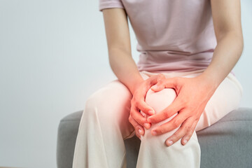 Asia female athlete or spot woman having knee injury due to ligament inflammation, knee pain due to...