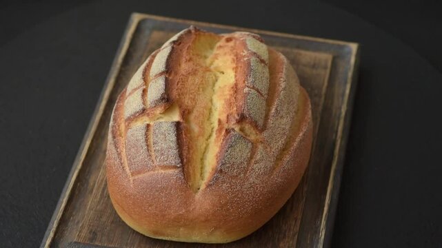 Homemade fresh crispy wholemeal bread on dark concrete background