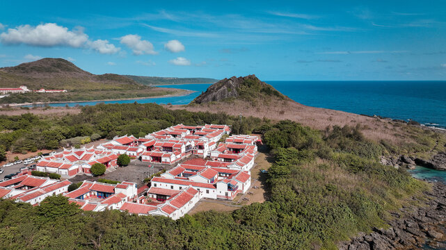 Scenic view of Kenting Baishawan coastline with colorful buildings and nearby mountains