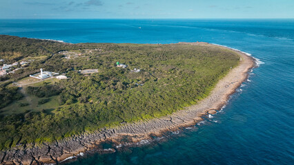 Eluanbi Lighthouse in Taiwan stands against turquoise waters at sunset
