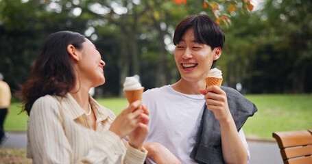 Couple, date and laugh in park with ice cream, bonding and share memories in Osaka. Japanese people, happy and outdoor with dessert snack for relationship development, funny story or travel with love