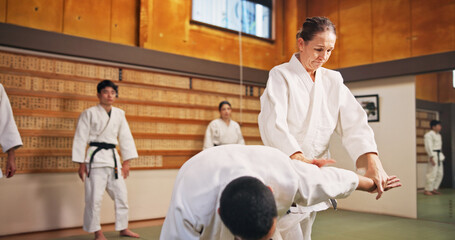 Karate demonstration, submission and teacher with students in dojo for fitness or training....