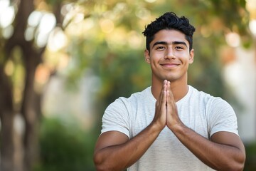 Man with hands together in a gesture of thanks