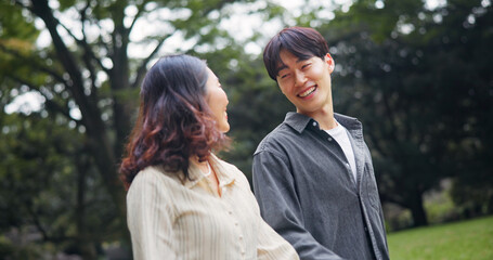 Japanese couple, smile and walk at park for holiday, support or healthy relationship together. Asian man, woman and travel on date at garden outdoor for romantic connection, love or happy on vacation