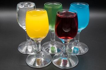 Colorful alcohol in shot glasses.
