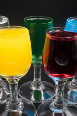 Colorful alcohol in shot glasses.
