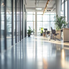 Fototapeta premium Out of focus background of modern office or coworking space with large windows and plants. copyspace
