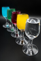Colorful alcohol in shot glasses.
