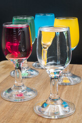 Colorful alcohol in shot glasses.
