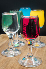 Colorful alcohol in shot glasses.
