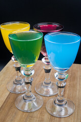Colorful alcohol in shot glasses.

