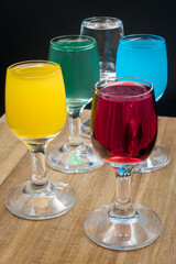 Colorful alcohol in shot glasses.
