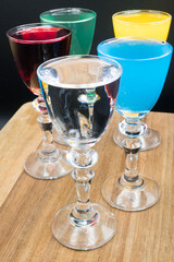 Colorful alcohol in shot glasses.
