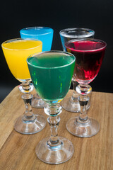Colorful alcohol in shot glasses.
