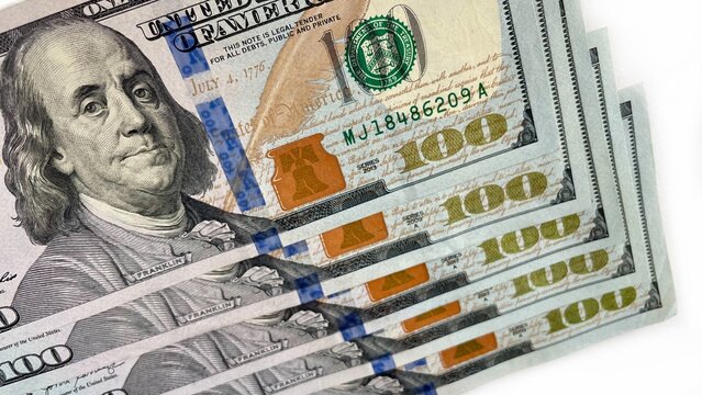 A fanned arrangement of 100 U.S. bills on a clean white background, symbolizing wealth, finance, and prosperity. Suitable for content related to banking, financial services, or economic growth.
