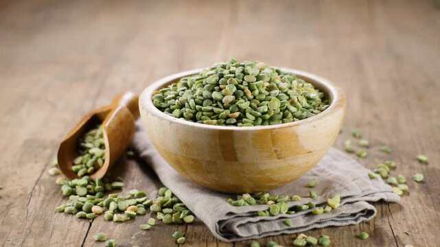 dried split green peas on wooden background