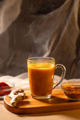 Immunity drink with turmeric powder. Turmeric tea. Trendy healthy drink with curcuma spices. Herbal beverage for health and normal bowel function