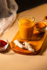 Steaming cup of herbal tea on wooden tray. Cozy atmosphere for winter evening. Concept of relax and didgital detox at home