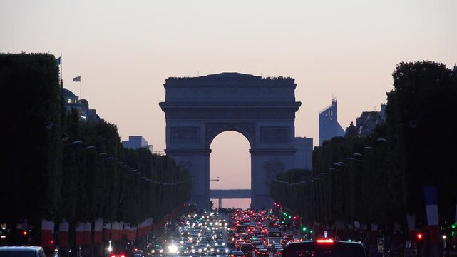 PARIS, FRANCE, SEPTEMBER 29, 2023 Traffic on Champs Elysees, Triumph Arch in Night, Traveling in France at Sunset in Twilight