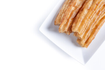 Spanish Churros. Traditional spanish food isolated on white background. Top view. Copy space