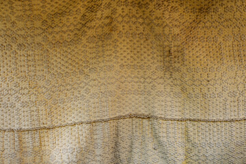 old vintage discolored embroidery bed cover