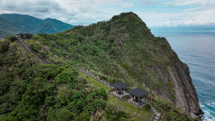 Hikers enjoy breathtaking views along the Dashibishan Trail in Taiwan on a cloudy day