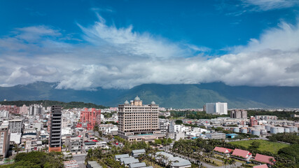 Panoramic view of Hualien, Taiwan capturing cityscape and mountains under a cloudy sky