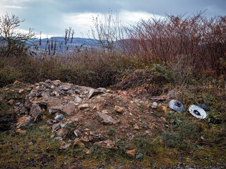 An illegal construction waste dump located in the wild near the city.There are also pieces of electrical installation material at the landfill.