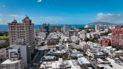 Obraz premium Aerial view of Hualien city with coastline and stunning blue sky in Taiwan during afternoon