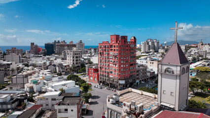 Fototapeta premium Aerial view of Hualien city showcasing vibrant buildings and a church against a clear sky