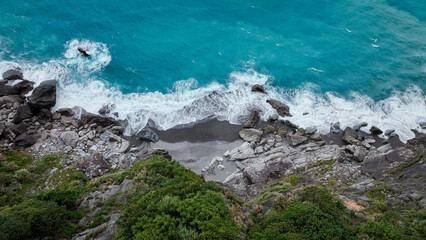 Serene coastline view of Hualien, Taiwan featuring turquoise waves and rocky shore