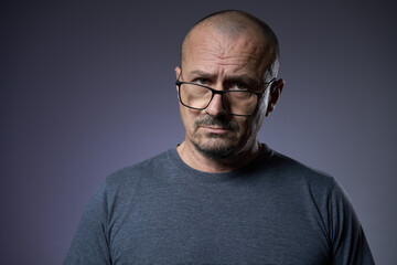 Mature man with an expression of skepticism
