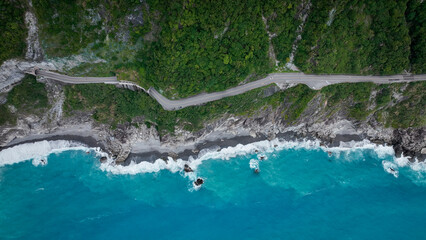 Aerial view of Hualiens coastline and winding road along the vibrant blue ocean © Dave