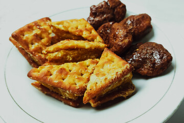 Taripang biscuits and cakes are placed on a white plate on a plain white table