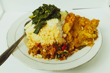 Rice mixed with fried omelet on a white plate on the table