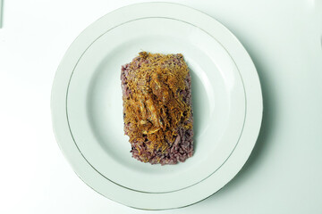 Black Glutinous Rice on a white plate on the dining table in the dining room