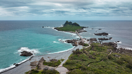 Coastal view of Sanxiantai, Taiwan, featuring lush greenery and turquoise waters