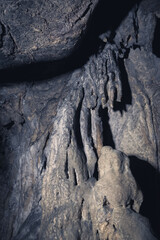Fototapeta premium A rock with an irregular shape extends downwards like a sheet of cloth in the Bukit Buntu Kesu Tana Toraja cave