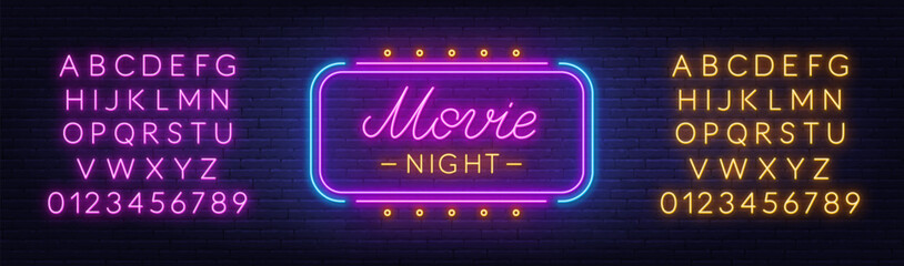 Movie Night Neon Sign on brick wall background. Light text announcement. Pink and yellow neon alphabet.