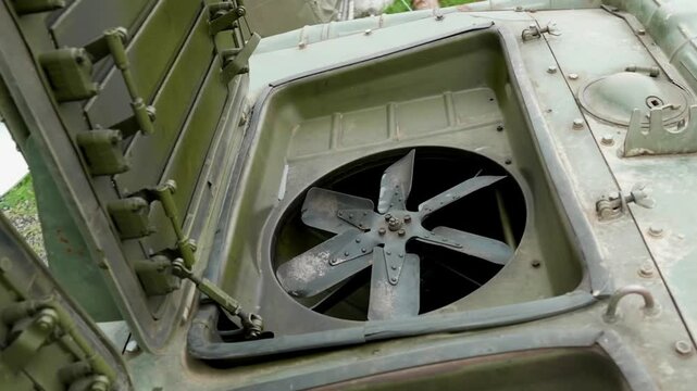 Discover the engine compartment of the BTR-70 Soviet armored vehicle with details on the radiator, spark plugs, and pipes.