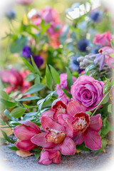 A small funeral flower arrangement. A beautiful memorial bouquet at the cemetery. The memorial flowers include red orchids. 