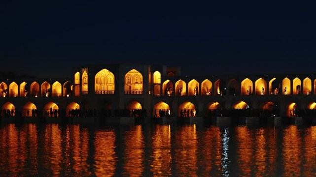 The breathtaking and timeless beauty of Khaju Bridge in Isfahan, Iran, is a 17th-century architectural icon. After sunset, the stunning view of the bridge reflected in the waters of Zayandeh River