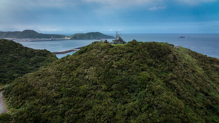 Obraz premium Aerial view of Nanfangaos green hills above the calm coastline and ocean