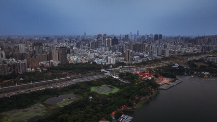 Kaohsiung city skyline at dusk with urban development and distant lights reflected on the water
