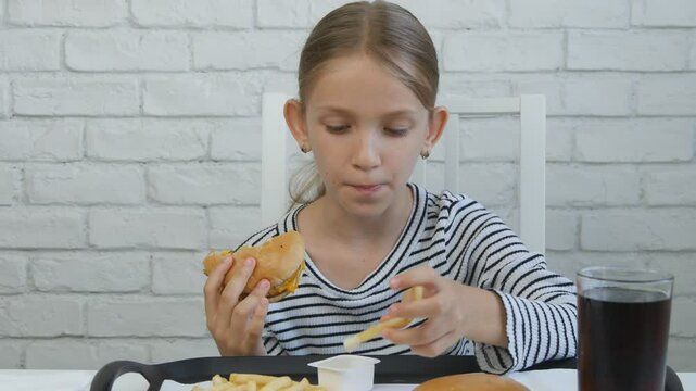 Kid Eating Fast Food, Child Eats Hamburger in Restaurant, Hungry Teenager Blonde Girl with Cheeseburger Sandwiches, Drinking Juice