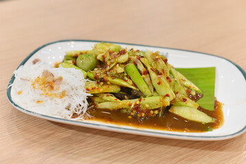 Spicy cucumber salad on wooden table, Thai spicy food