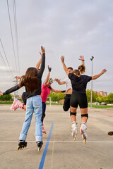 Rollerblading group celebrating with a synchronized jump in the park