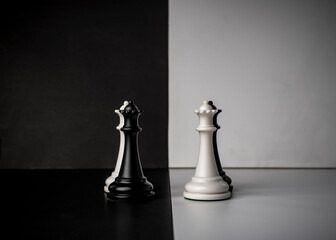 Conceptual composition with chess pieces in dramatic light, duality, good versus evil, darkness...