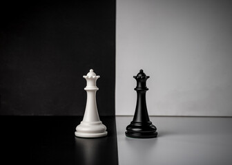 Conceptual composition with chess pieces in dramatic light, duality, good versus evil, darkness...