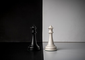 Conceptual composition with chess pieces in dramatic light, duality, good versus evil, darkness...